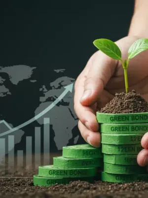 Hands holding a seedling on green bonds, symbolizing sustainable investment growth.