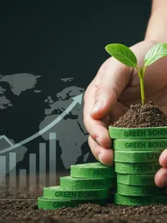 Hands holding a seedling on green bonds, symbolizing sustainable investment growth.