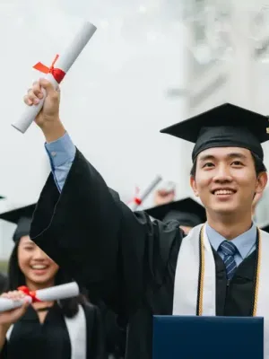 Graduates celebrating with diplomas, symbolizing hope for student loan debt relief in 2026.